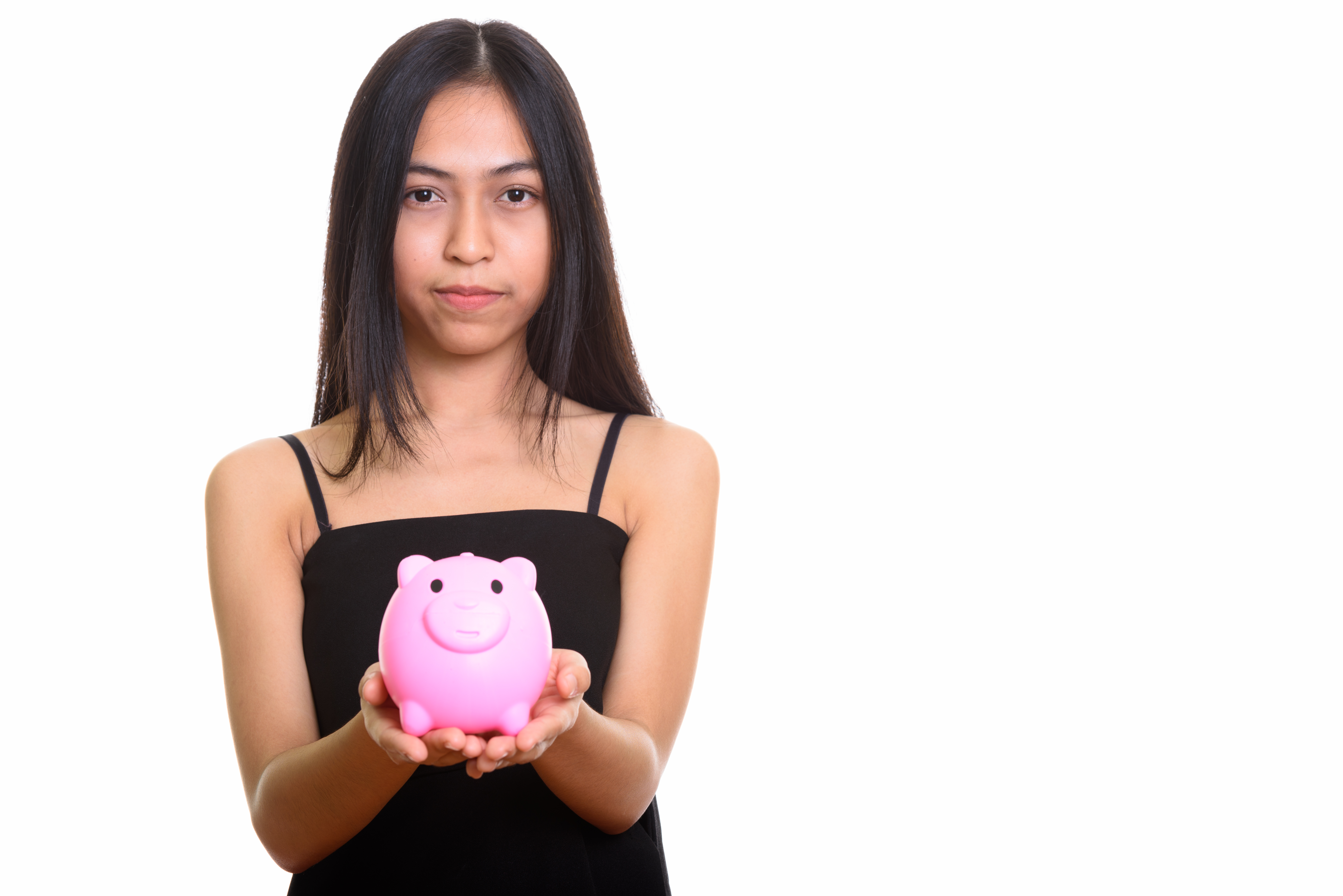 Teen girl holding a piggy bank