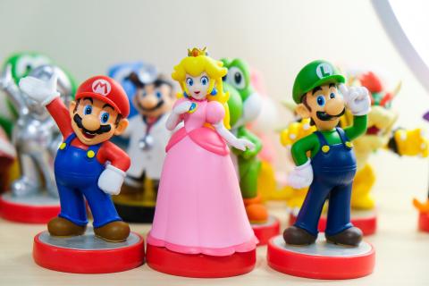 Toy figurines of Mario, Princess Peach, and Luigi
