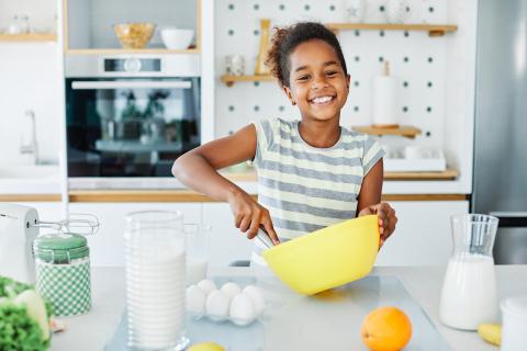 Girl in kitchen with mixing bowl