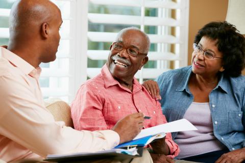 older couple meeting with someone and talking.