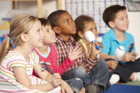 Kids sitting and playing instruments