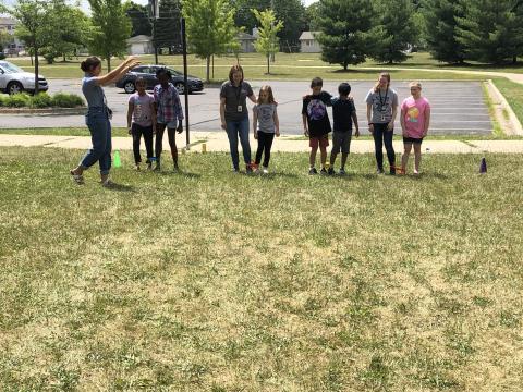 Kids in a three-legged race outside