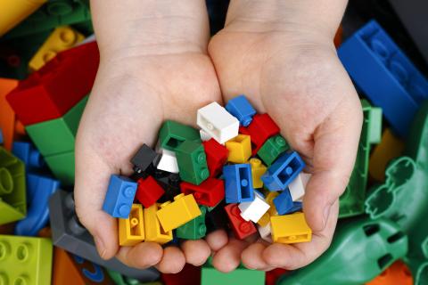 hands holding lego bricks