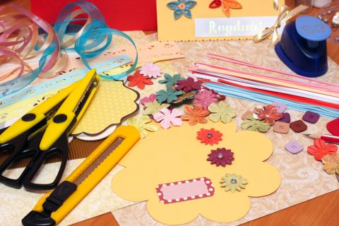 various craft supplies displayed out on a wooden table.