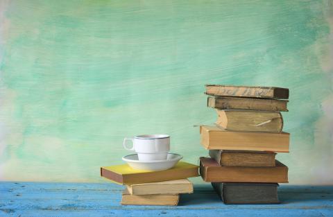 books stacked on top of each other with a green background.