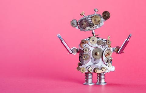 Silver robot on a pink background