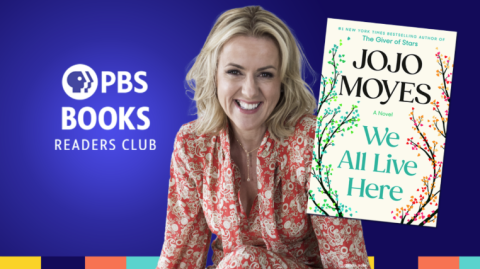 Photo of JoJo Moyes with her book We All Live Here in front of her