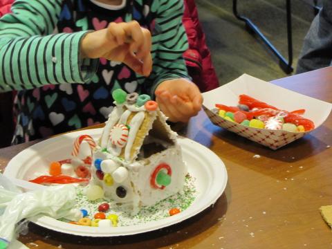 kid making a gingerbread house