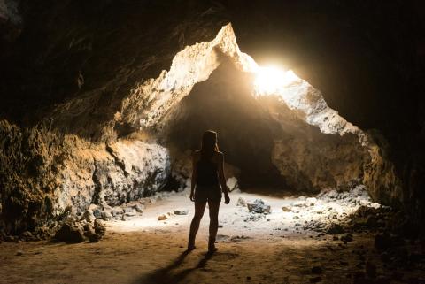 Woman standing in cave