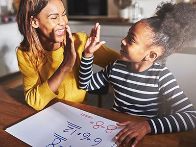 Girl and mother slapping high five