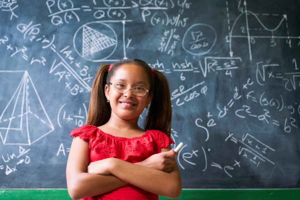 Girl standing in front of a chalkboard