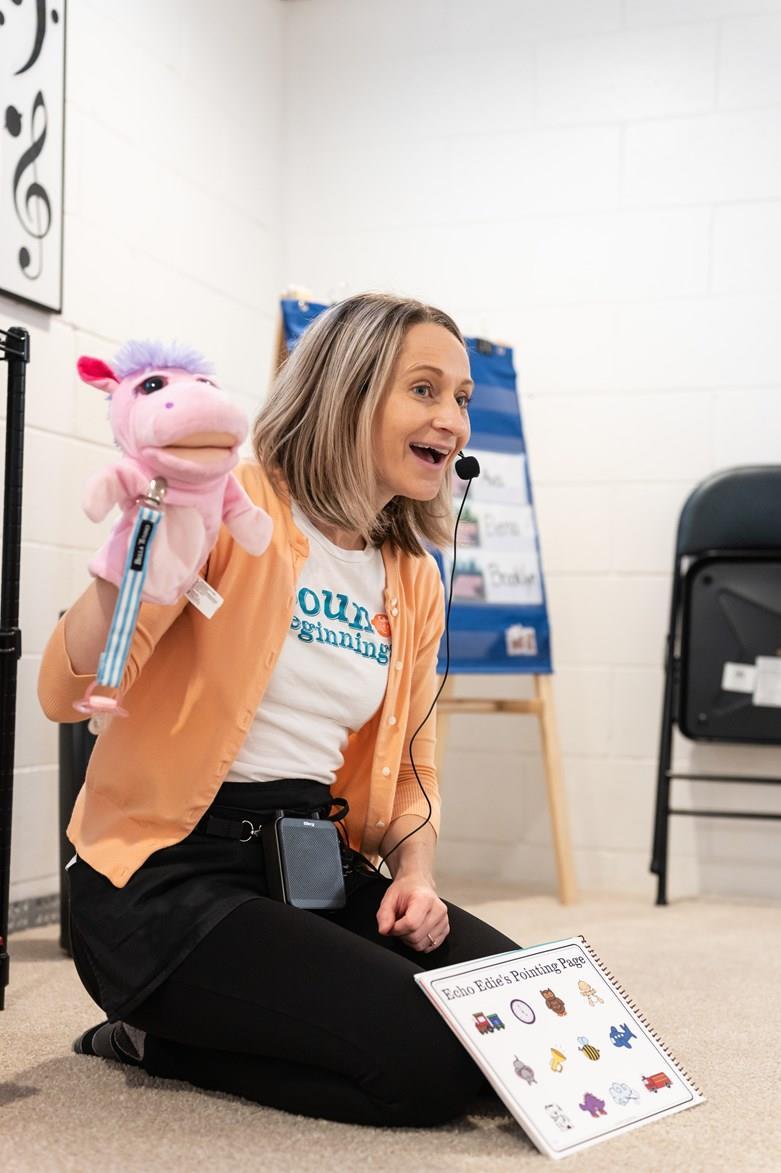 Miss Maggie singing with a puppet