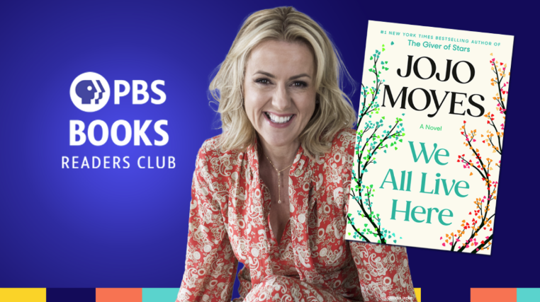 Photo of JoJo Moyes with her book We All Live Here in front of her