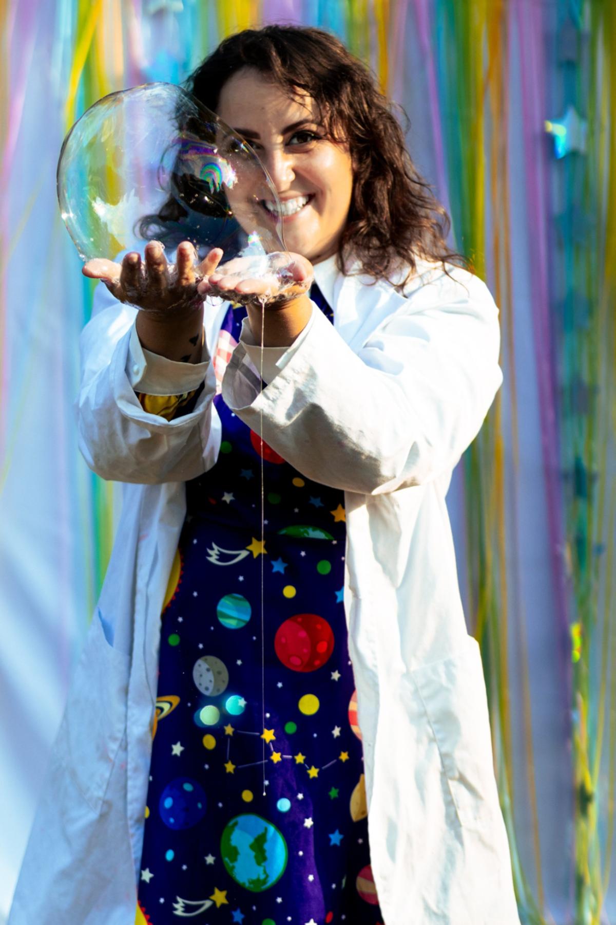 Woman holding a bubble Angelina from Michigan Bubble Fun